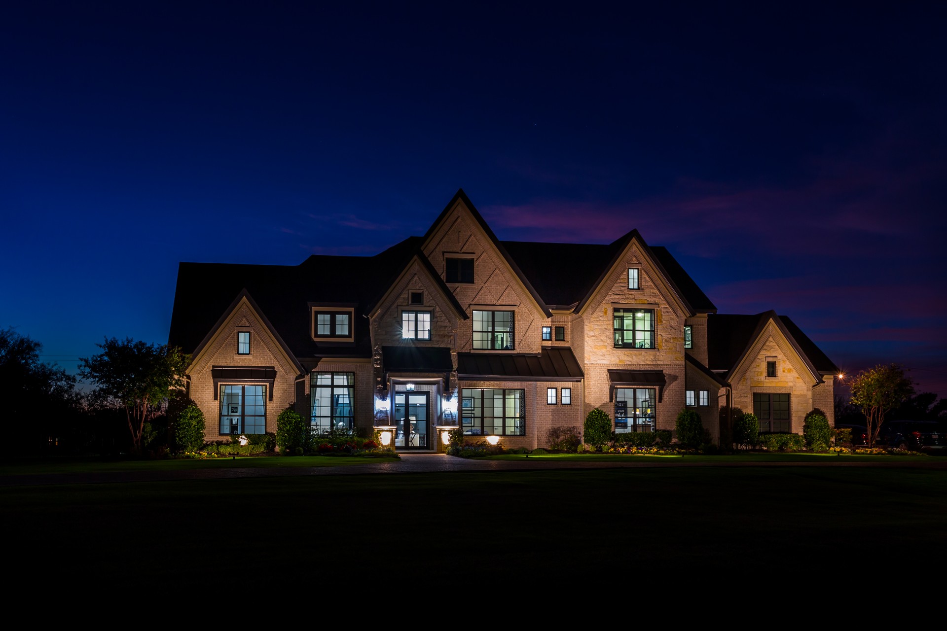 Luxury Grand Homes community office illuminated at night