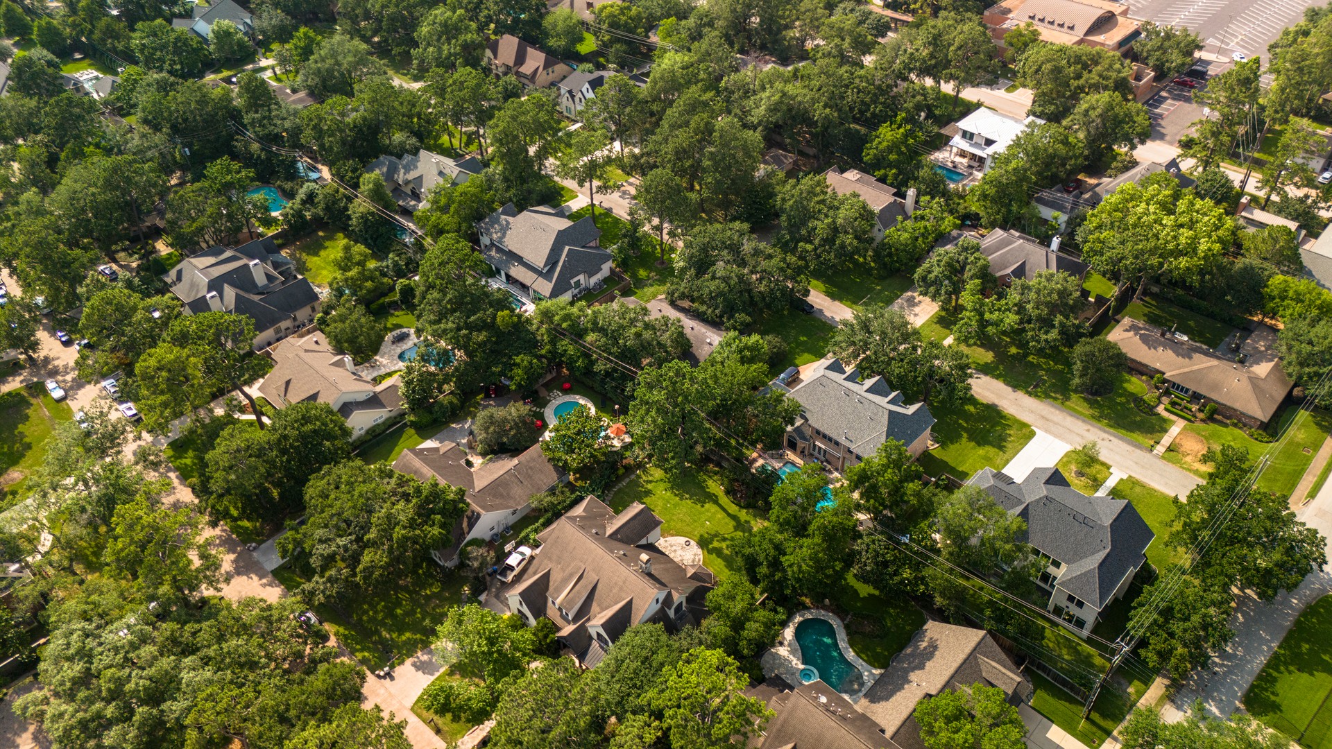 Navigating East Houston green neighborhood in Texas. Diverse wealthy homes and pools in tree-lined suburban Spring Branch, TX